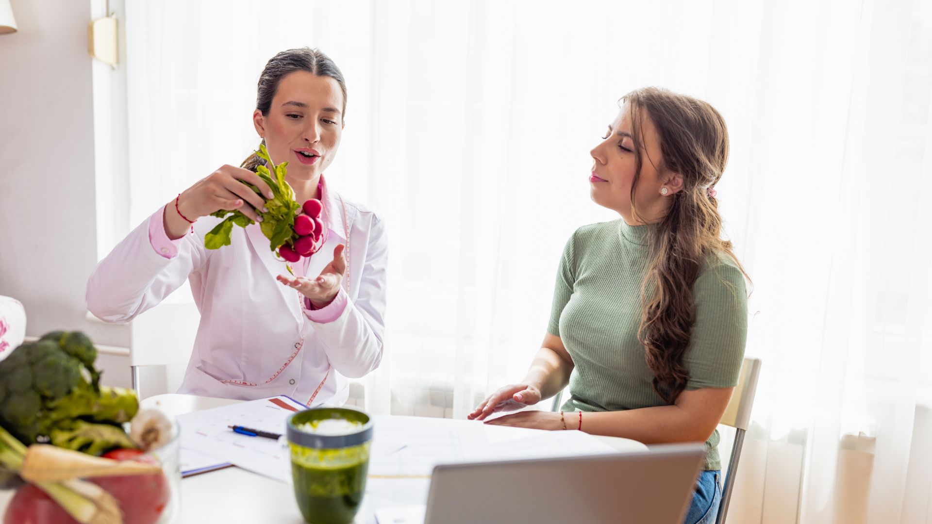 A woman sitting at a table with another woman